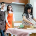 Parents watching their children spending time in the kitchen