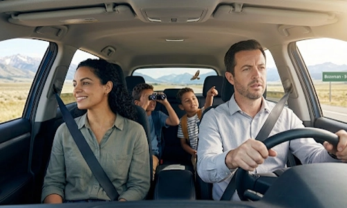 Family enjoying a scenic road trip together during a surprise vacation getaway