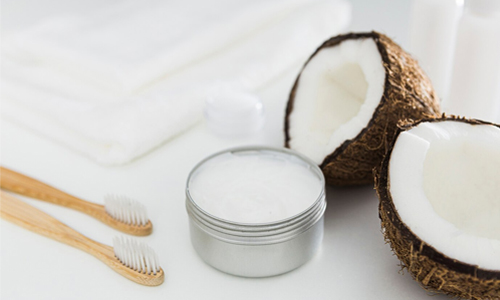 Coconut with coconut oil and brush