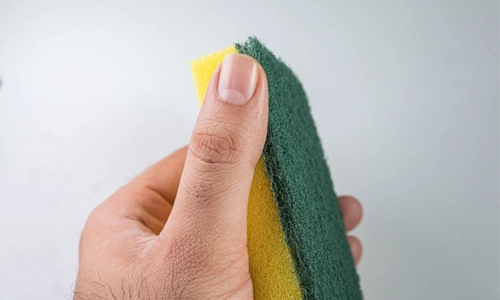 using a sponge to clean pet hair from furniture