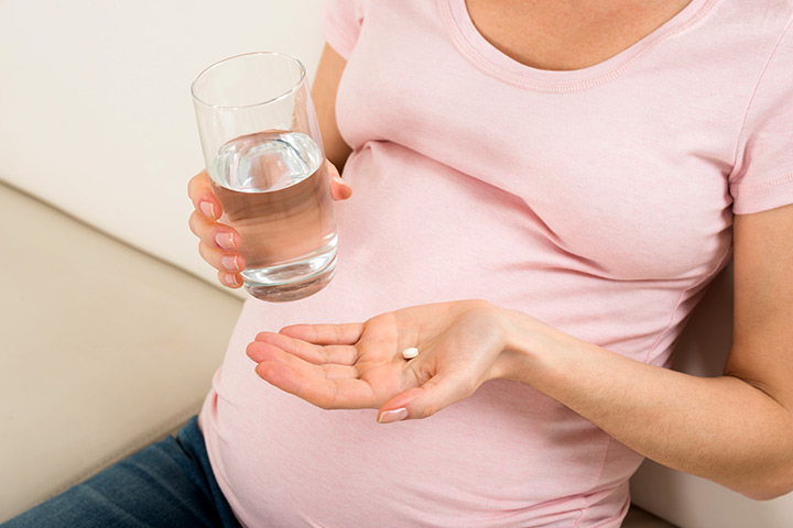 Pregnant woman taking supplements