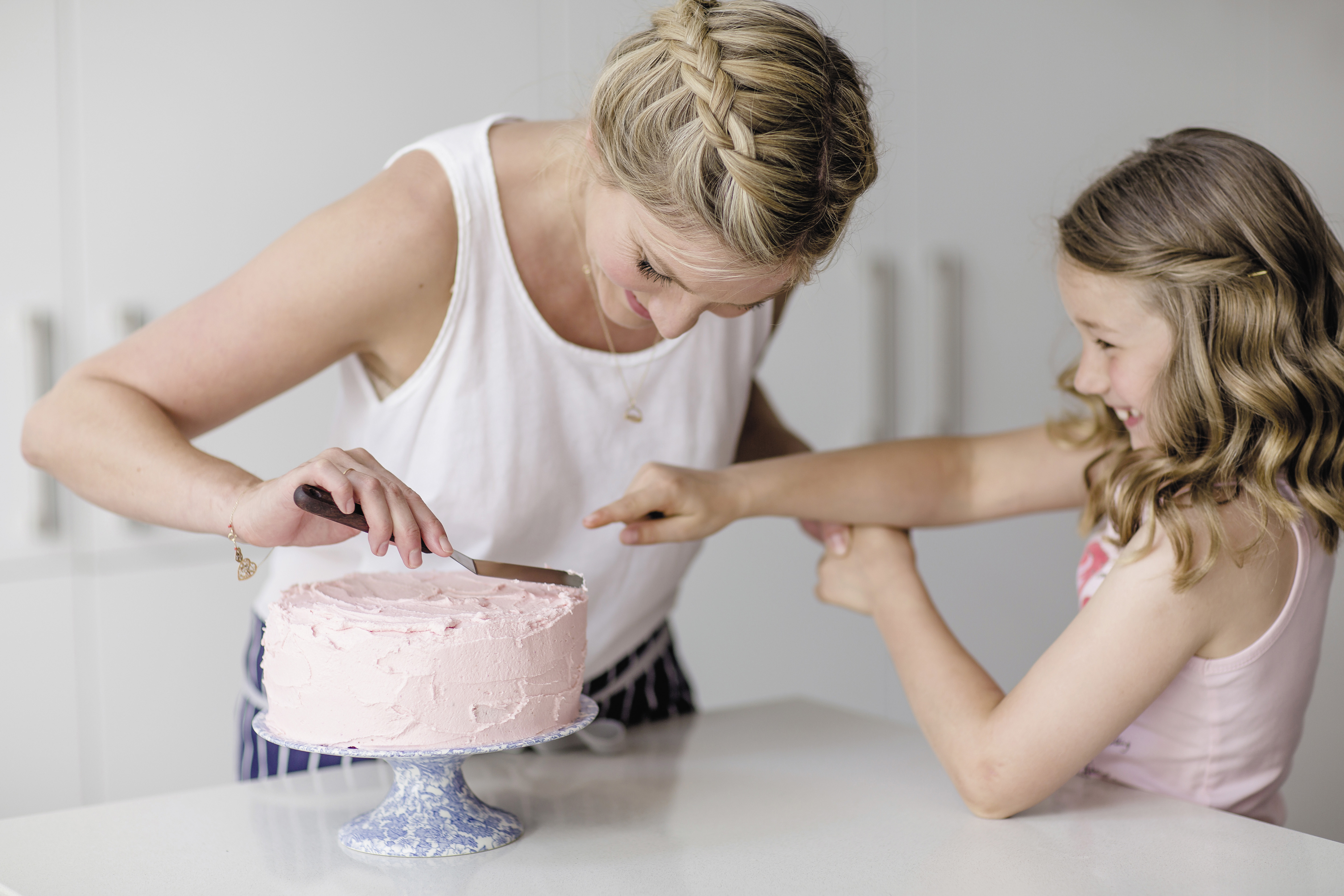 Mom & Daughter icing a cake