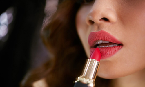 Girl applying lipstick