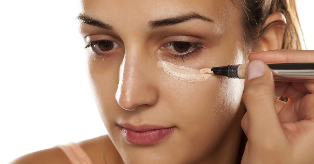 Applying concealer