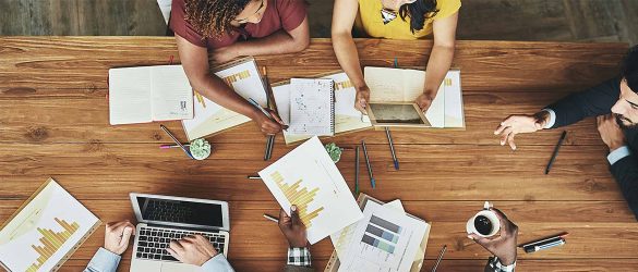 Aerial view of a work desk with co-workers in it.