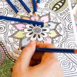 Colouring a mandala design.