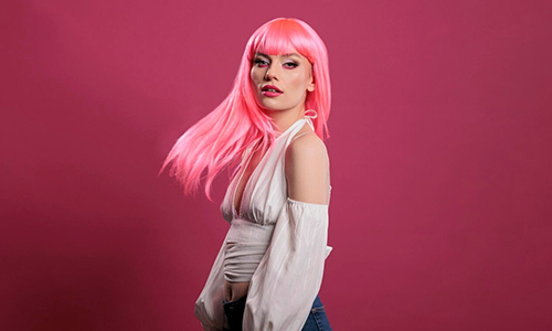 A young woman with cool pink colored hair