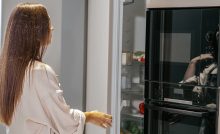 Woman opening fridge