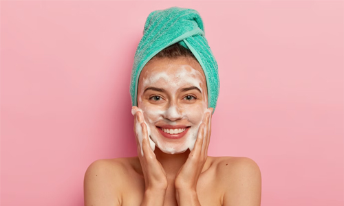 A woman cleaning her face