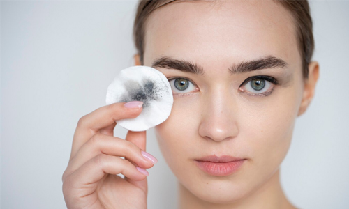 A woman with a make-up remover pad