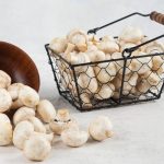 Mushrooms-inside-the-wooden-cup-and-the-metallic-basket