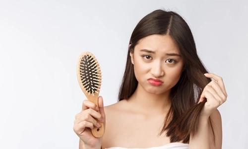 Portrait of Stressed woman holding a comb and dry over white background