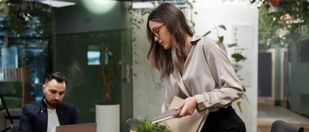 Woman holding a cardboard box for leaving her office