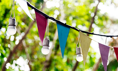 Colorful paper decorations and lights set up for a party