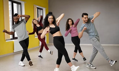 Group of adults dancing together during a fitness class in a studio