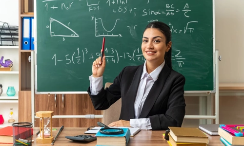 Image of a woman school teacher sitting in a classroom